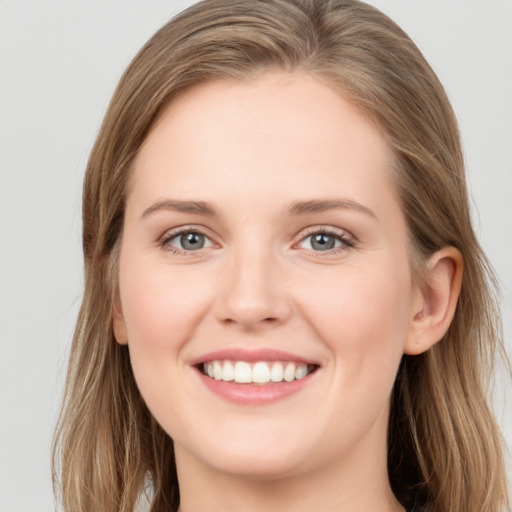 Joyful white young-adult female with long  brown hair and grey eyes