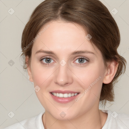 Joyful white young-adult female with medium  brown hair and green eyes