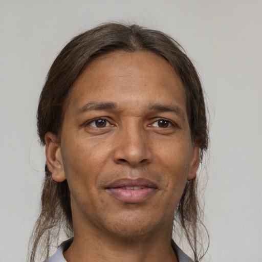 Joyful latino adult male with medium  brown hair and brown eyes