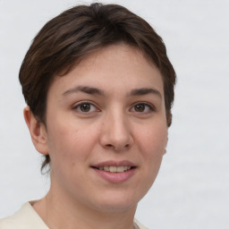 Joyful white young-adult female with short  brown hair and grey eyes