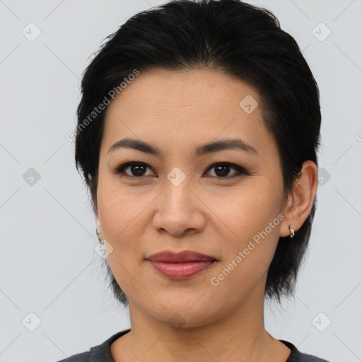 Joyful asian young-adult female with medium  black hair and brown eyes