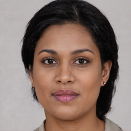 Joyful asian young-adult female with medium  brown hair and brown eyes