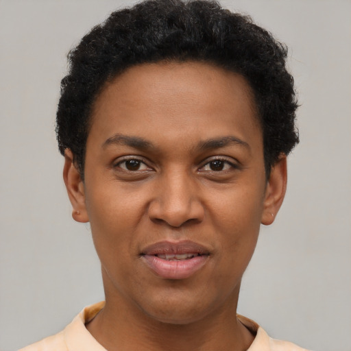 Joyful black young-adult female with short  black hair and brown eyes