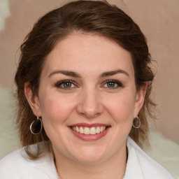 Joyful white young-adult female with medium  brown hair and green eyes