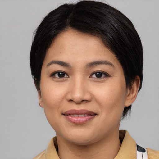 Joyful asian young-adult female with medium  black hair and brown eyes