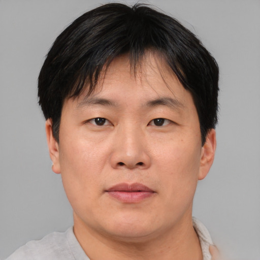 Neutral asian adult male with short  brown hair and brown eyes