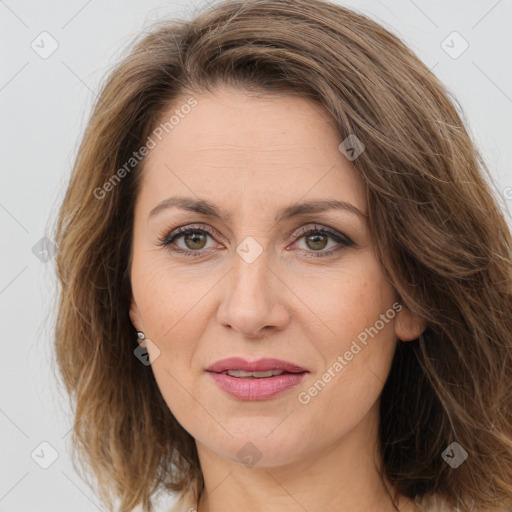 Joyful white adult female with long  brown hair and brown eyes