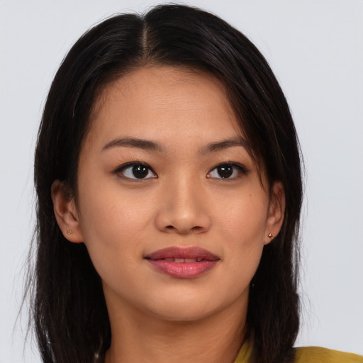 Joyful asian young-adult female with long  brown hair and brown eyes