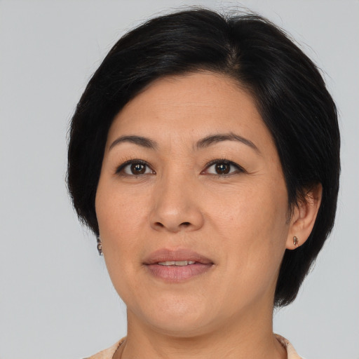Joyful asian adult female with medium  brown hair and brown eyes