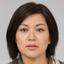 Neutral asian young-adult female with medium  brown hair and brown eyes