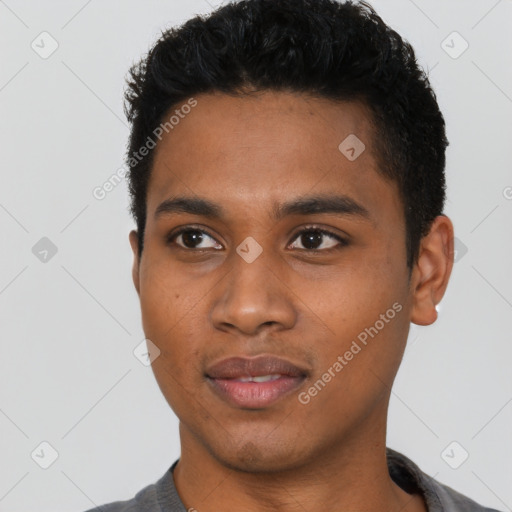 Joyful black young-adult male with short  black hair and brown eyes