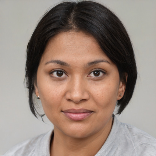 Joyful asian young-adult female with medium  brown hair and brown eyes