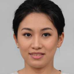 Joyful asian young-adult female with short  brown hair and brown eyes