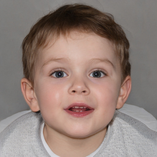 Joyful white child male with short  brown hair and blue eyes