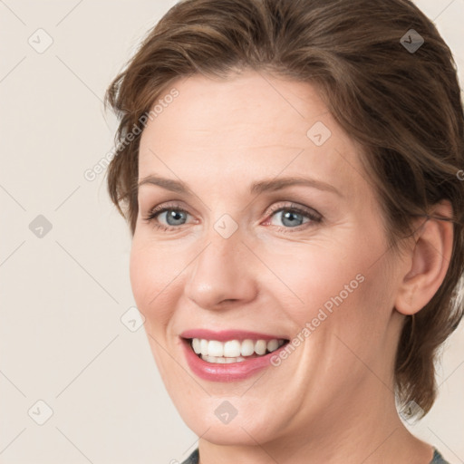 Joyful white young-adult female with medium  brown hair and grey eyes