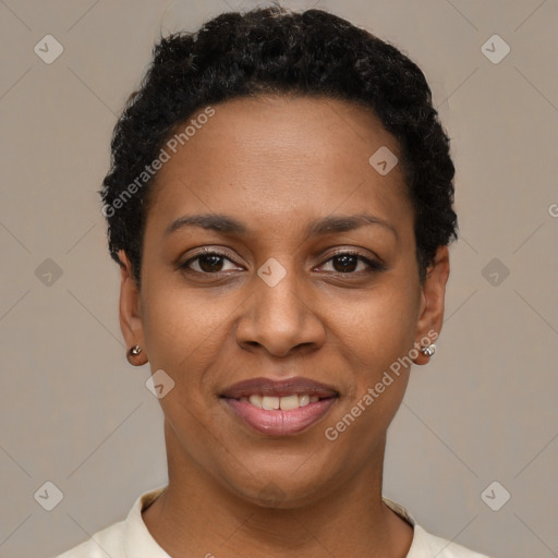 Joyful black young-adult female with short  black hair and brown eyes