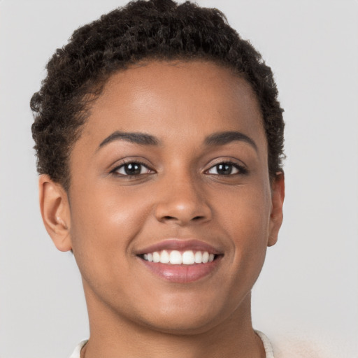 Joyful latino young-adult female with short  brown hair and brown eyes