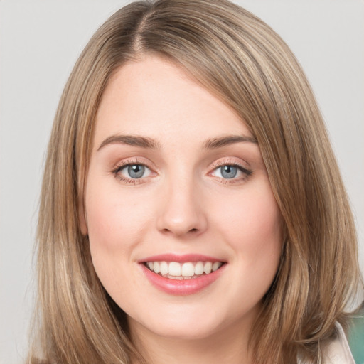 Joyful white young-adult female with medium  brown hair and green eyes