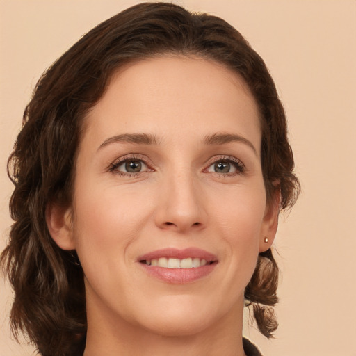 Joyful white young-adult female with medium  brown hair and green eyes