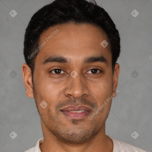 Joyful latino young-adult male with short  black hair and brown eyes