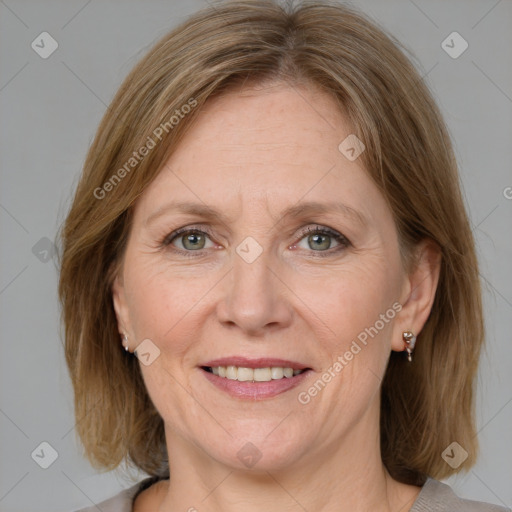 Joyful white adult female with medium  brown hair and grey eyes