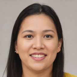 Joyful asian young-adult female with long  brown hair and brown eyes