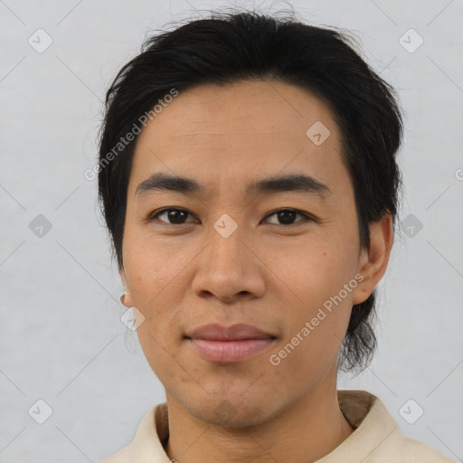 Joyful asian young-adult male with medium  brown hair and brown eyes