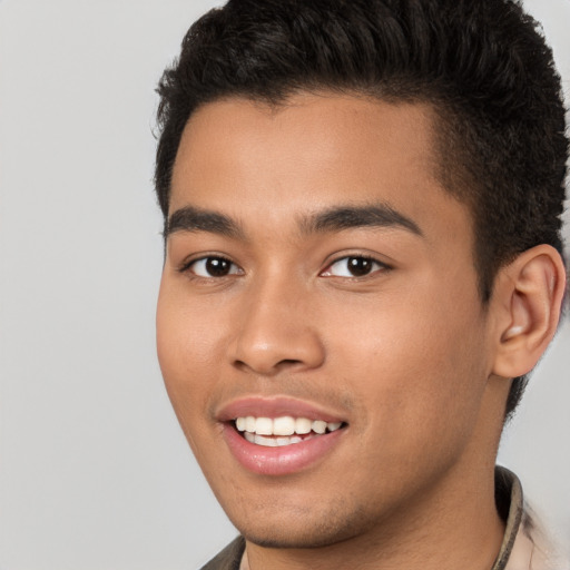 Joyful latino young-adult male with short  brown hair and brown eyes