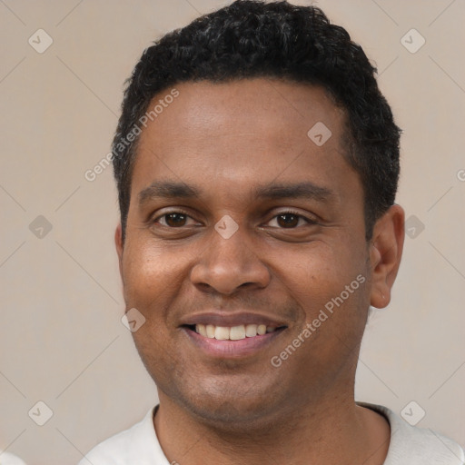 Joyful latino young-adult male with short  black hair and brown eyes