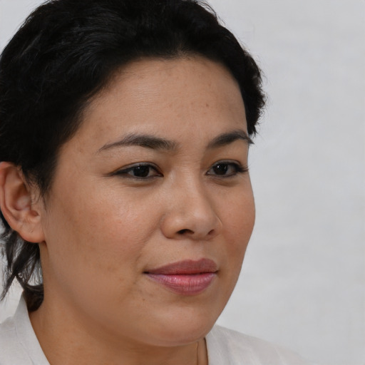 Joyful asian young-adult female with short  brown hair and brown eyes
