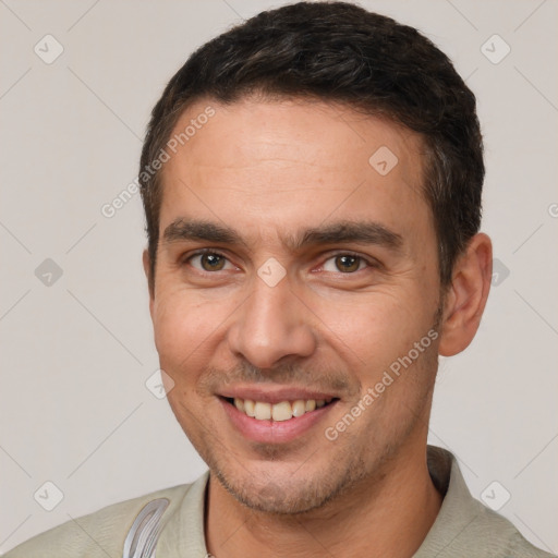 Joyful white young-adult male with short  brown hair and brown eyes