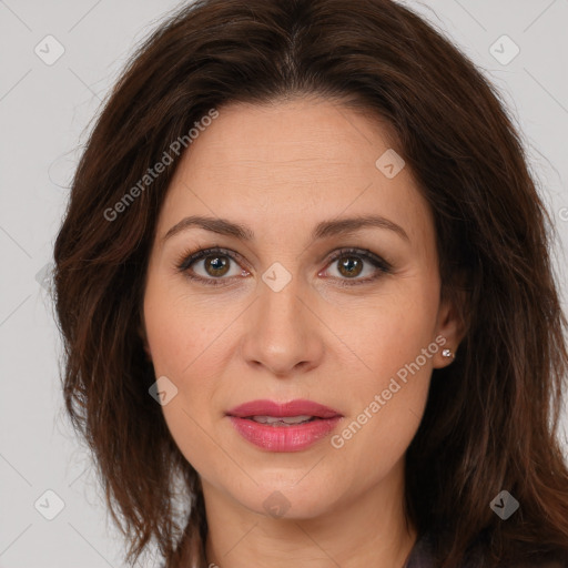 Joyful white adult female with long  brown hair and brown eyes