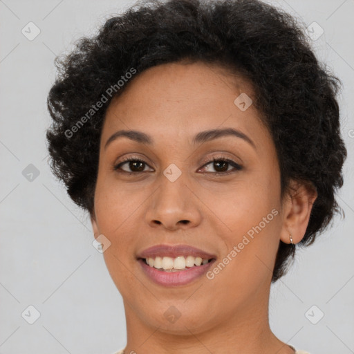 Joyful black young-adult female with short  brown hair and brown eyes