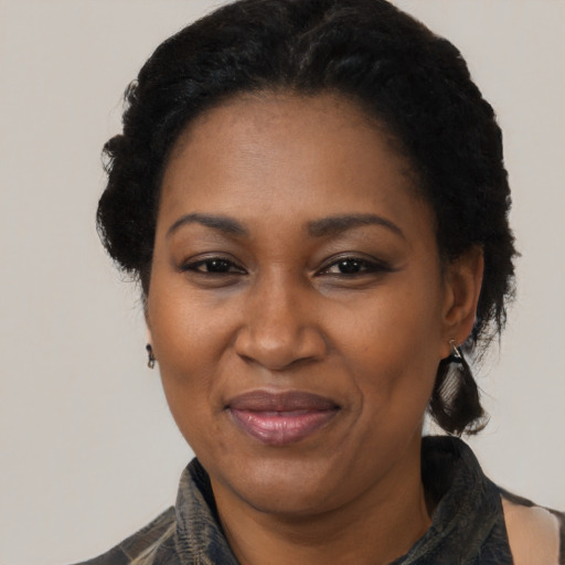 Joyful black adult female with short  black hair and brown eyes