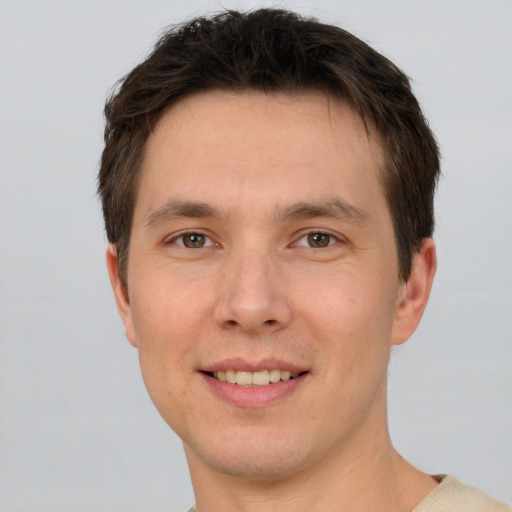 Joyful white young-adult male with short  brown hair and brown eyes