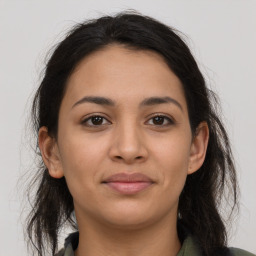 Joyful latino young-adult female with long  brown hair and brown eyes