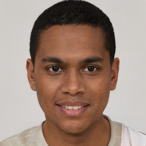 Joyful black young-adult male with short  black hair and brown eyes