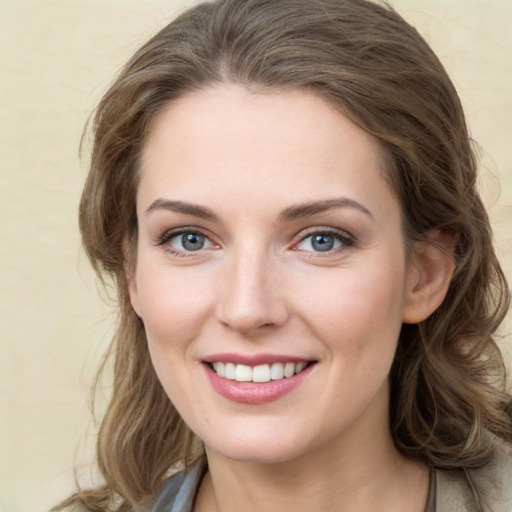 Joyful white young-adult female with medium  brown hair and green eyes