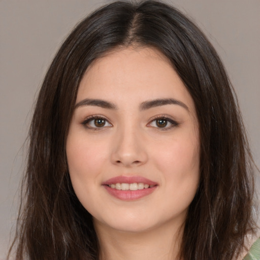 Joyful white young-adult female with long  brown hair and brown eyes