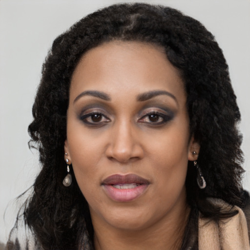 Joyful black young-adult female with long  black hair and brown eyes