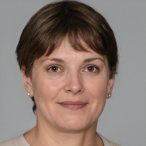 Joyful white adult female with medium  brown hair and grey eyes