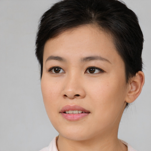 Joyful asian young-adult female with short  brown hair and brown eyes