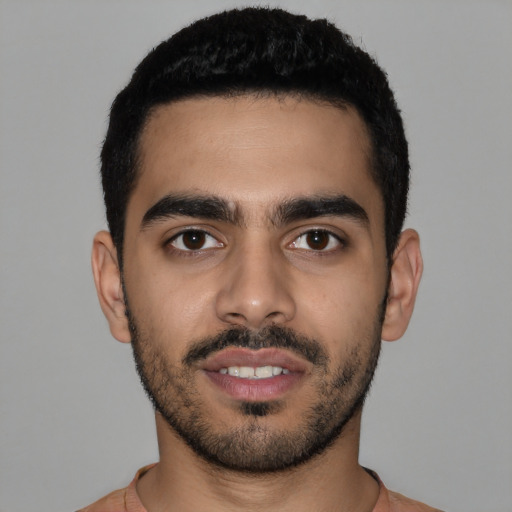 Joyful latino young-adult male with short  black hair and brown eyes