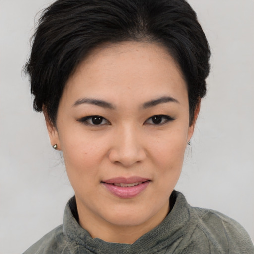 Joyful asian young-adult female with short  brown hair and brown eyes