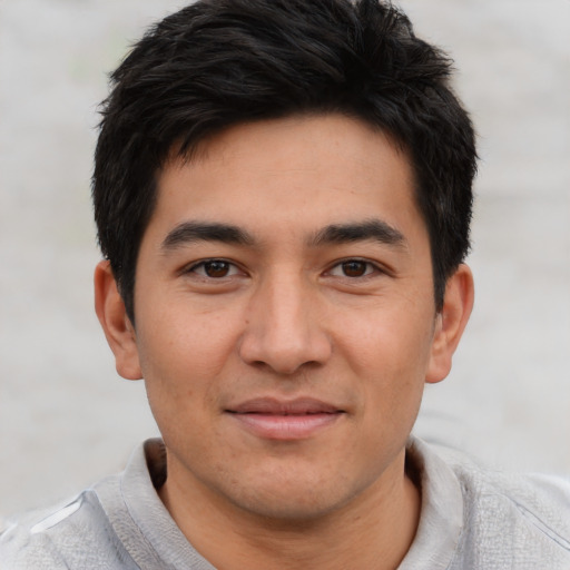 Joyful asian young-adult male with short  brown hair and brown eyes