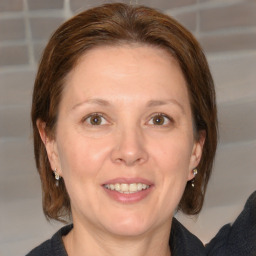 Joyful white adult female with medium  brown hair and grey eyes