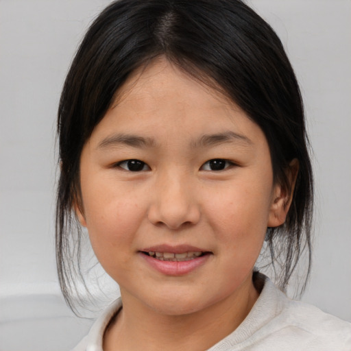 Joyful asian child female with medium  brown hair and brown eyes