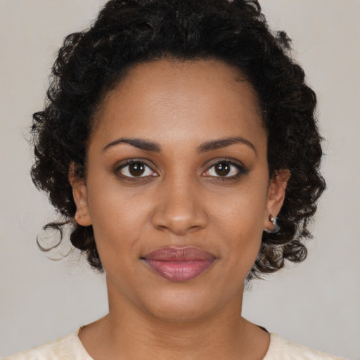 Joyful black young-adult female with medium  brown hair and brown eyes