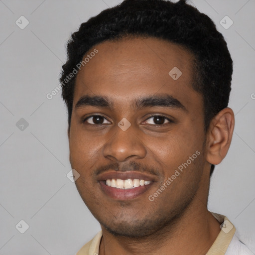 Joyful black young-adult male with short  black hair and brown eyes