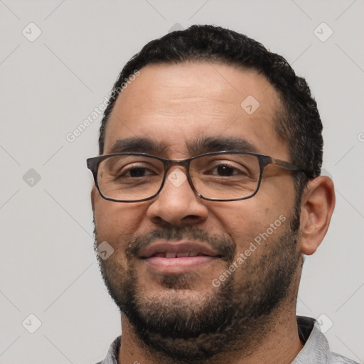 Joyful white adult male with short  black hair and brown eyes